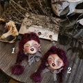 Two purple-haired Lambwick doll earrings with lace collars, labeled 1 and 2.