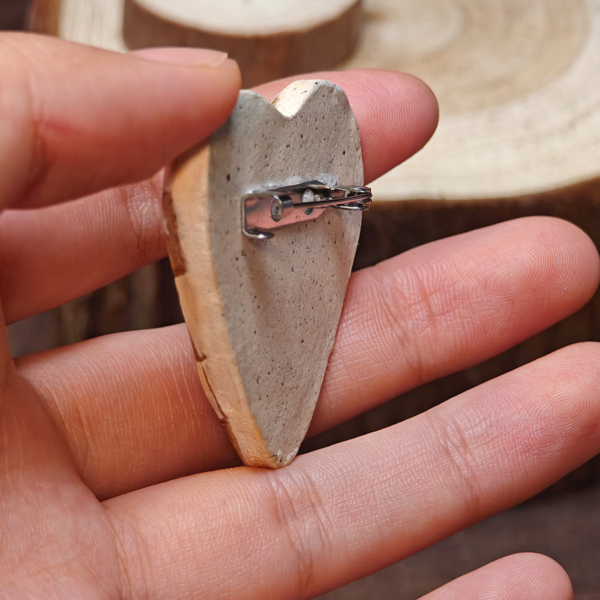 Side and back of a Winterwood brooch showing its thickness and metal pin.