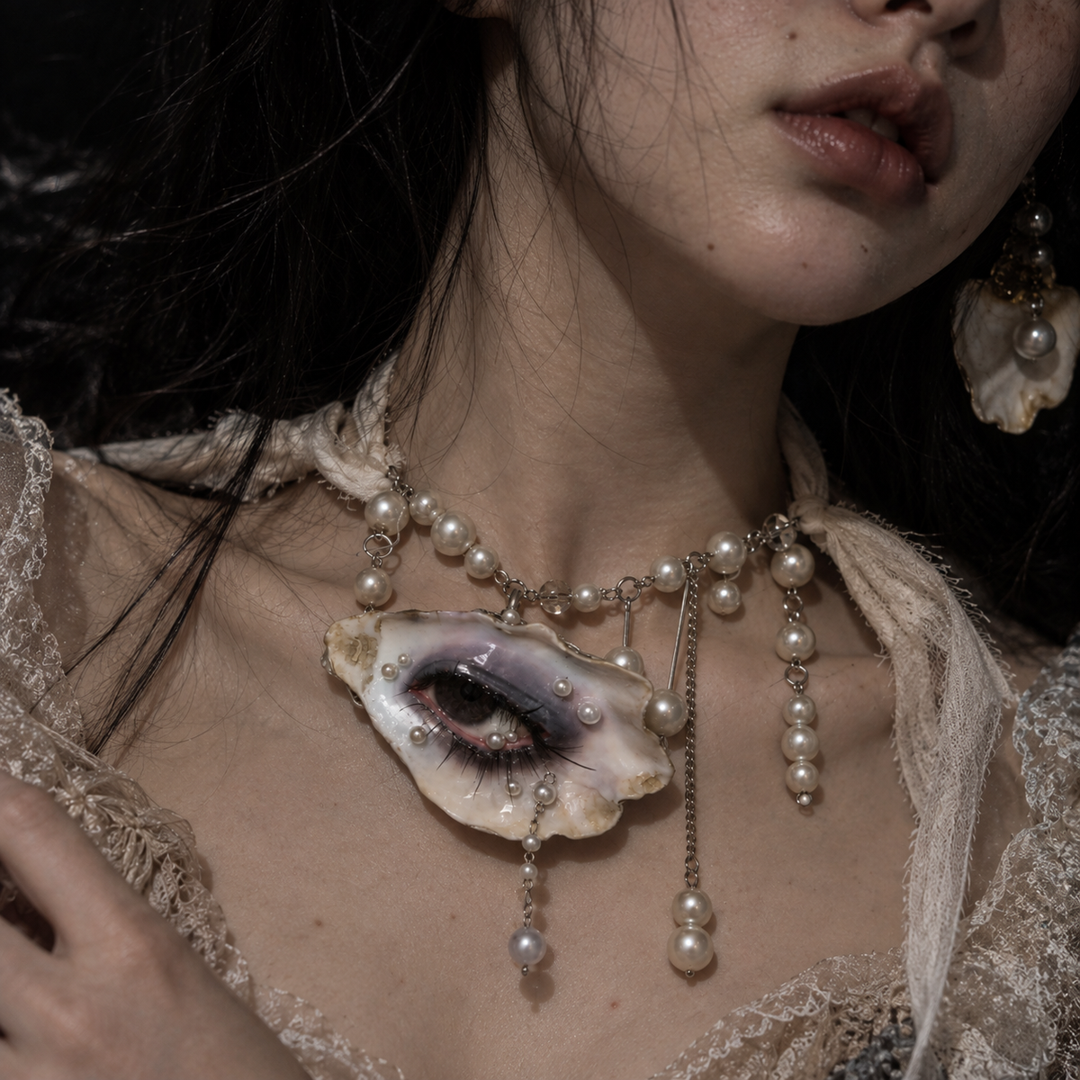 Vespera faux pearl-accented chain necklace on model, angled view