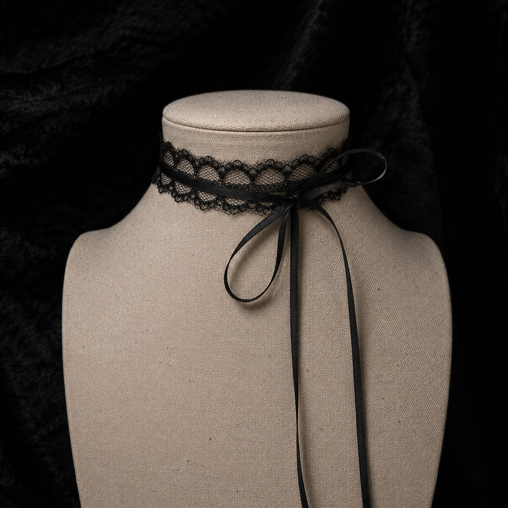 Fine black lace choker tied with a bow on a jewelry bust.