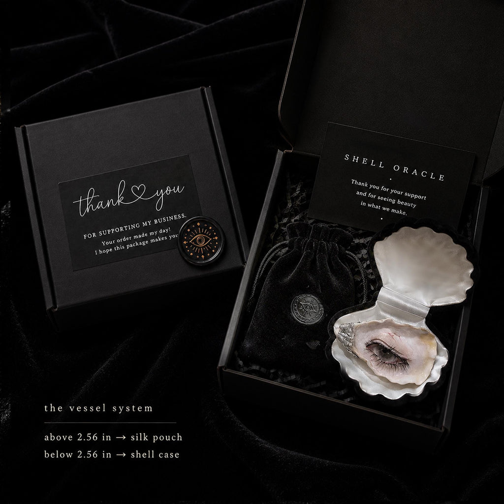 Shell Oracle packaging reference showing a presentation box, pouch and example shell-eye artwork.