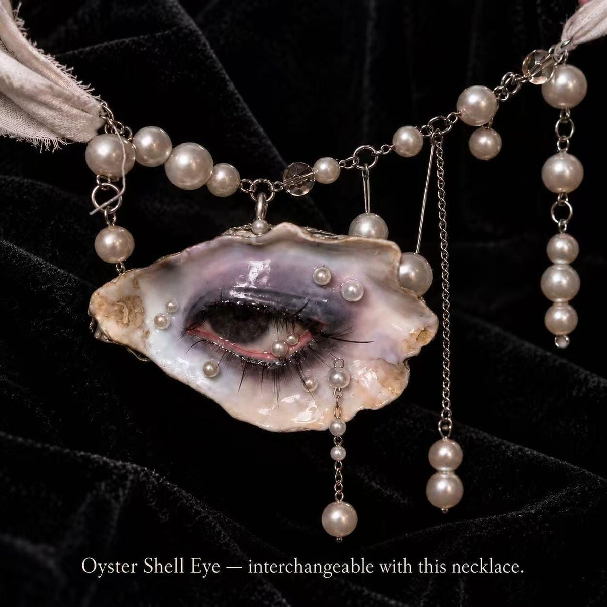 Reference necklace with a different shell-eye piece, showing the interchangeable pearl-accented attachment.