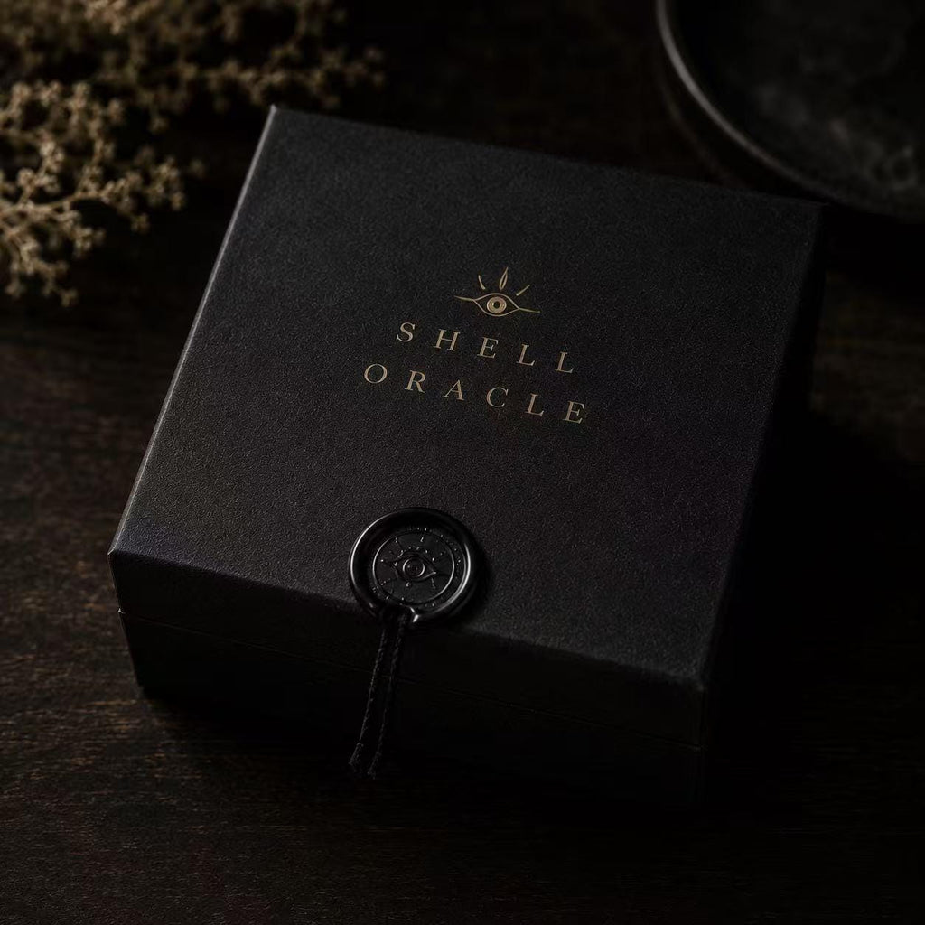 Black Shell Oracle presentation box with a circular seal.