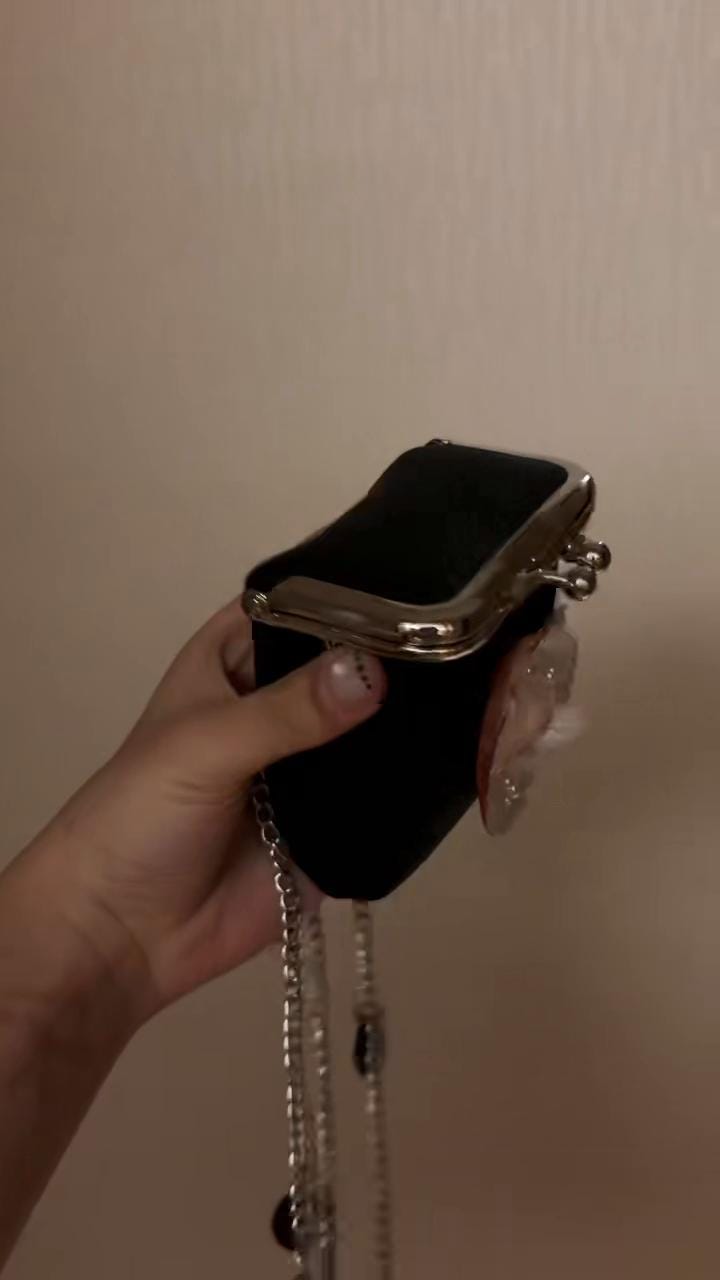 Open clasp and black interior of the Oyster Eye Mini Crossbody Bag, shown from the side.