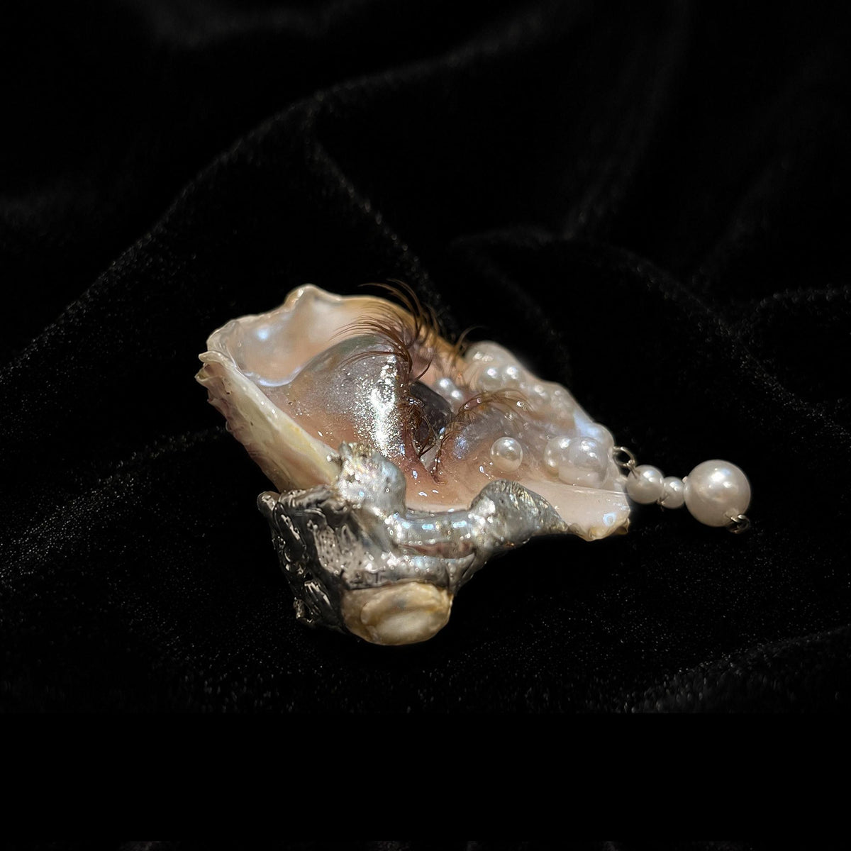 Side view of Brown Smoky Oyster Eye showing the shell depth and raised sculpted eyelid.