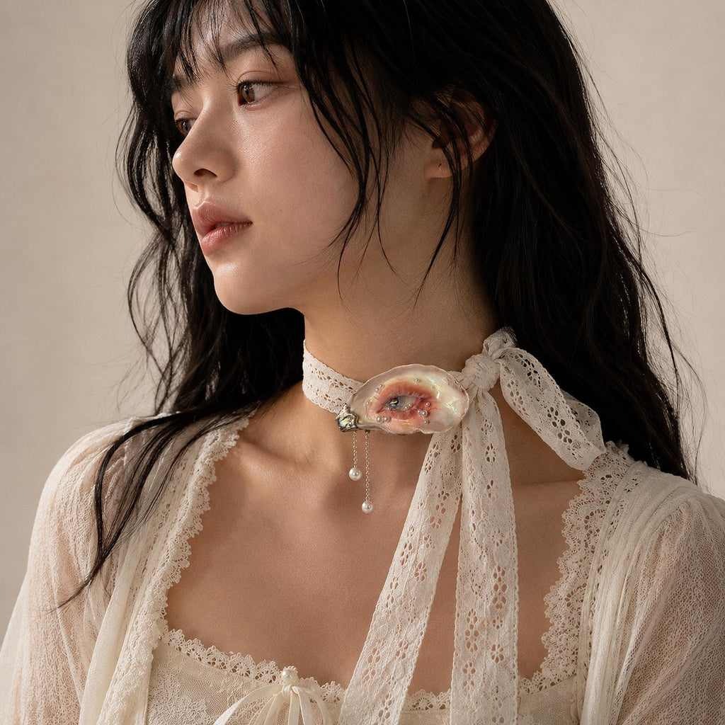 White-Lash Blue Oyster Eye worn as a white lace-ribbon choker.