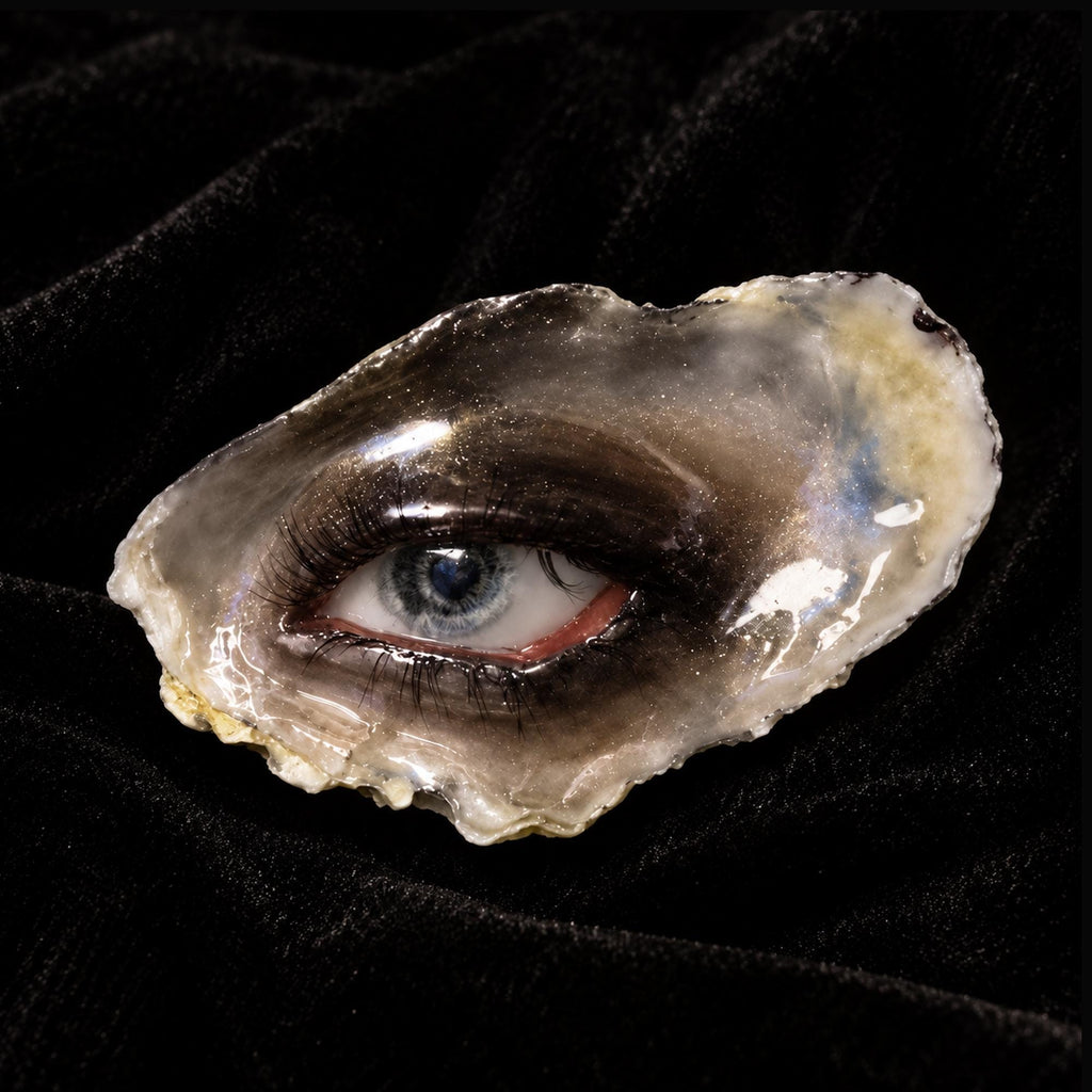 Lilith Grey Temptation oyster eye resting on black velvet in a front view.