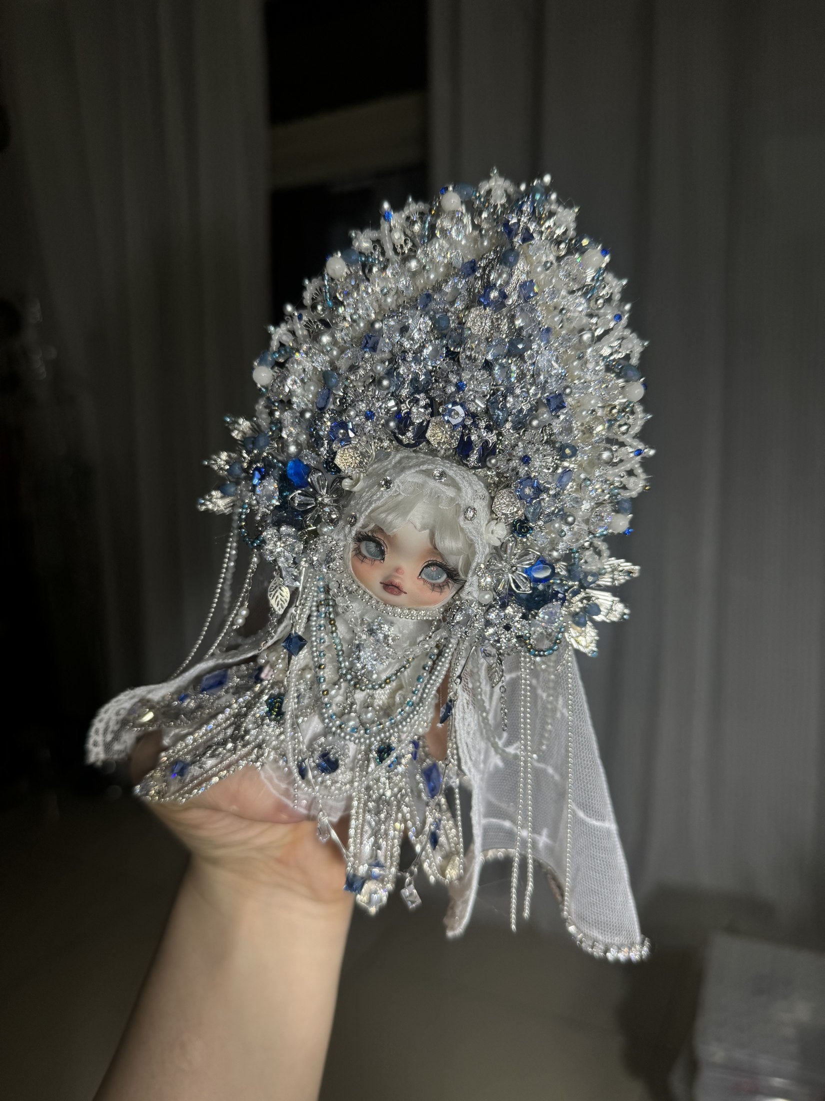 A pale blue art doll with an elaborate silver crown and cascading beadwork, archive tuntun-007